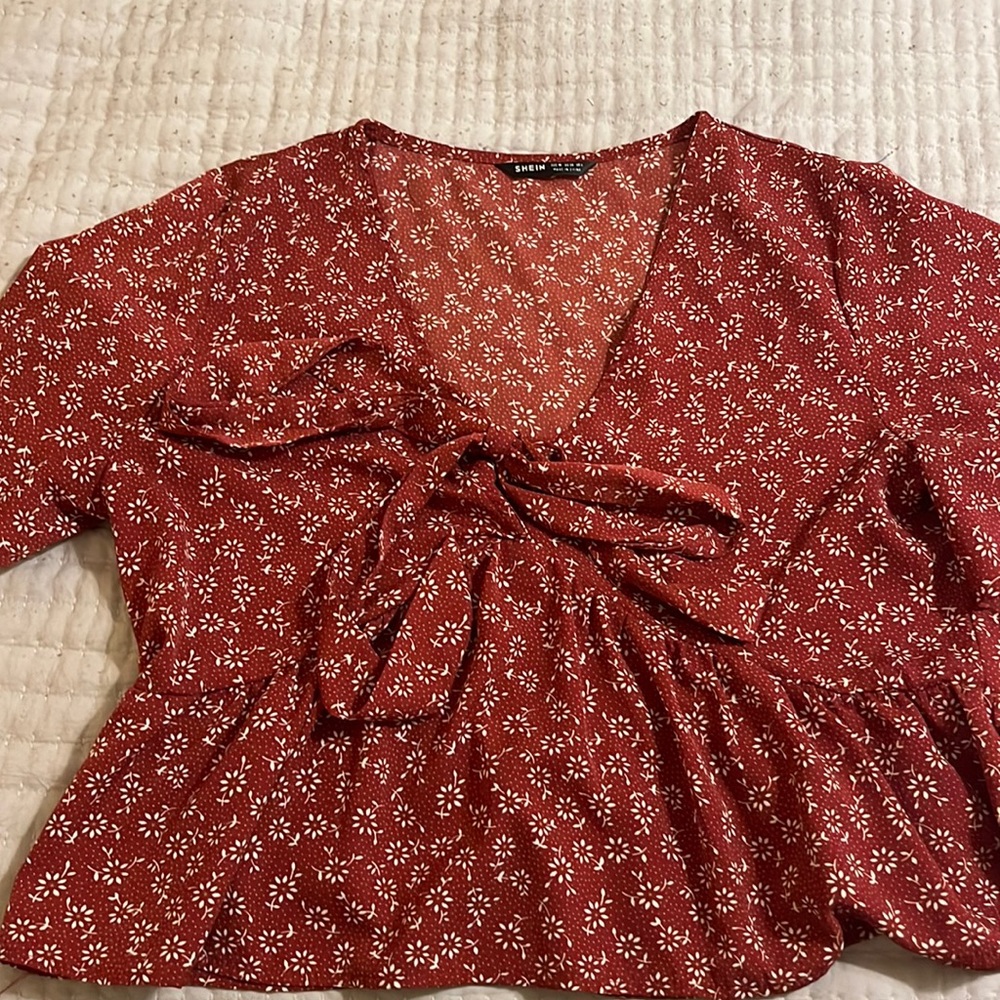 Medium red shirt that ties in the front. Never worn.